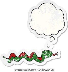 cartoon snake with thought bubble as a distressed worn sticker