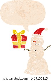 cartoon snowman with present with speech bubble in grunge distressed retro textured style