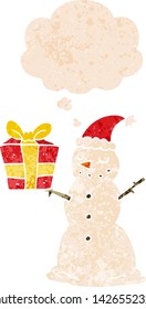 cartoon snowman with present with thought bubble in grunge distressed retro textured style