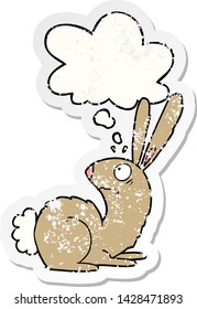 cartoon startled bunny rabbit with thought bubble as a distressed worn sticker