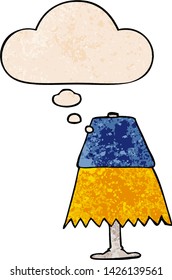 cartoon table lamp with thought bubble in grunge texture style