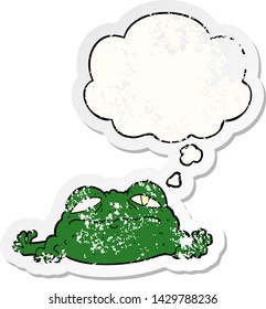 cartoon ugly frog with thought bubble as a distressed worn sticker
