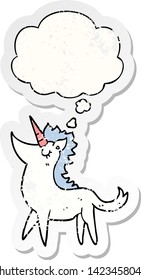 Cartoon-Einicorn mit Denkblase als bedrückter abgenutzter Aufkleber