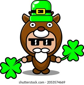 cartoon vector illustration of cute deer animal mascot costume character wearing st patrick's hat and holding clover