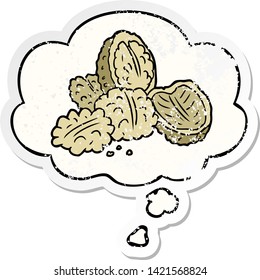 cartoon walnuts with thought bubble as a distressed worn sticker