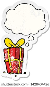 cartoon xmas present with thought bubble as a distressed worn sticker