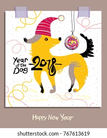 Cartoon Yellow Dog in a Santa cap and a Christmas ball. 2018. Happy New Year greeting card.