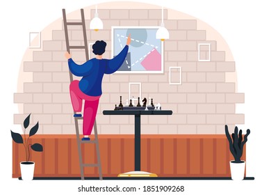 Cartoon young man going up the stairs hangs a picture on a brick wall in the room with chess on the table. Character is doing household chores. player in the living room near the chessboard