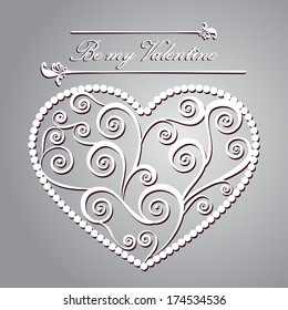 Carved paper heart with a pattern of curlicues to St. Valentine's day and weddings