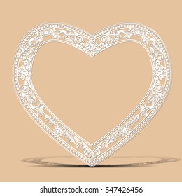 carved vintage frame made of paper for picture or photo with shadow on light background