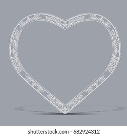 carved vintage frame made of paper for picture or photo with shadow on gray background