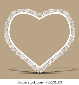 carved vintage frame made of paper for picture or photo with shadow on light background