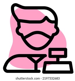 Cashier on cash counter with machine and mask.