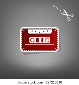 Cassette icon, audio tape sign. Vector. Red icon with for applique from paper with shadow on gray background with scissors.