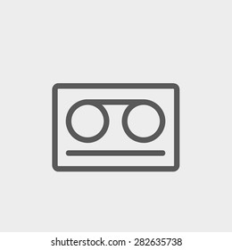 Cassette tape icon thin line for web and mobile, modern minimalistic flat design. Vector dark grey icon on light grey background.