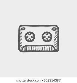 Cassette tape sketch icon for web and mobile. Hand drawn vector dark grey icon on light grey background.