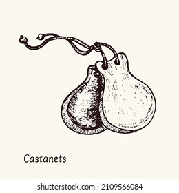 Castanets. Ink black and white doodle drawing in woodcut style with inscription.