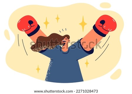 Casual woman in boxing gloves raises hands up after defeating rivals and becoming new champion by taking first place. Boxing gloves symbolize your determination to get job or education