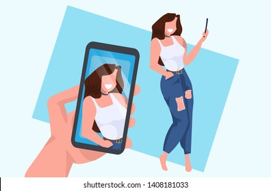 casual woman taking selfie on smartphone camera hand holding cellphone with photo on screen female cartoon character posing flat full length horizontal