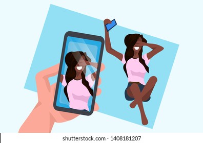 casual woman taking selfie on smartphone camera hand holding cellphone with photo on screen african american female cartoon character posing flat full length horizontal