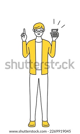 A casually dressed young man holding a calculator and pointing.