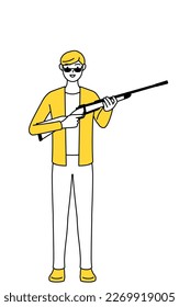 Un joven vestido de manera informal con gafas de sol y sosteniendo un rifle.