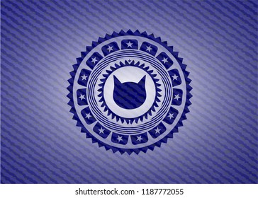 cat face icon inside badge with jean texture