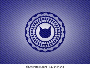 cat face icon inside emblem with jean background