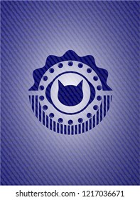 cat face icon inside emblem with jean background