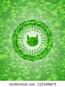 cat face icon inside green emblem with triangle mosaic background