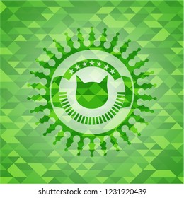 cat face icon inside green emblem. Mosaic background