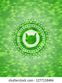 cat face icon inside green emblem with mosaic background