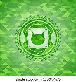 cat face icon inside green emblem with triangle mosaic background