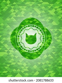 cat face icon inside green emblem with triangle mosaic background. 