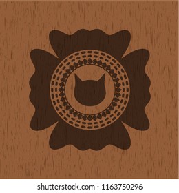 cat face icon inside realistic wood emblem