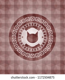 cat face icon inside red seamless emblem or badge with abstract geometric polygonal pattern background.