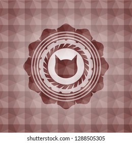 cat face icon inside red seamless emblem or badge with abstract geometric pattern background.
