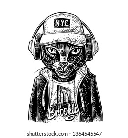 Cat To Headphones Dressed In The Hoodie, Baseball Cap, T-shirt With The Brooklyn Bridge. Vintage Black Engraving Illustration. Isolated On White Background. Hand Drawn Design Element For Poster