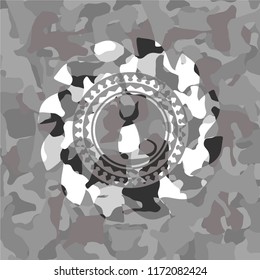 cat icon inside grey camouflaged emblem