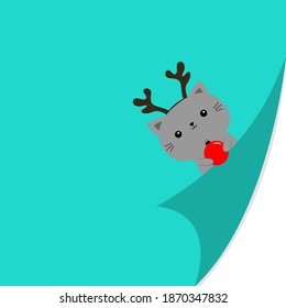 Cat kitten face holding xmas ball. Fold page corners. Deer reindeer horns. Merry Christmas. Curled paper corner. Cute cartoon kawaii funny baby animal character. Greeting card. Blue background. Vector