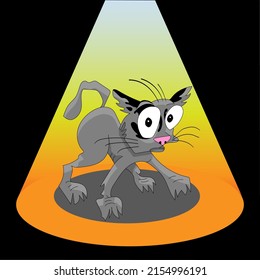 The cat is scared. Cute kitten under the lamp.