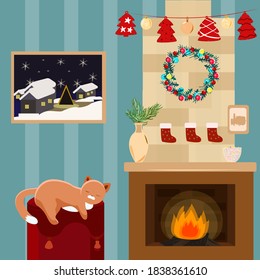 The cat sleeps near the fireplace decorated for Christmas on the Ottoman