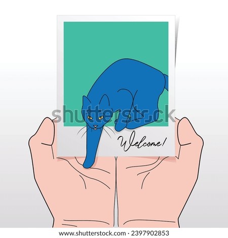 Cat Stepping On Outstretched Hands From Instant Print Photograph With Written Word “Welcome!” Referring To Rescuing, Fostering, Adopting A New Pet Cat Into A New Family From The Shelter, Homelessness