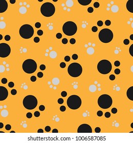 Cat's feet. Seamless pattern on a yellow background