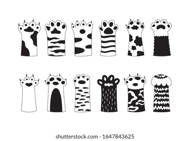 Cats paw decorated with patterns and spots black icons set, sketch cartoon vector illustration isolated on white background. Animal pets feet decorative prints.