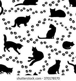 Cats seamless pattern. Kitten silhouette and animal tracks pattern over white background.