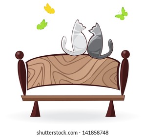cats sit on a bench and look at butterflies