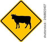 Cattle driving sign. Animals cross road. Beware of cattle crossing the road. Yellow diamond warning sign for cattle drive.