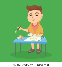 Caucasian boy standing near the table and painting with a paint brush and colorful paints. Happy boy drawing a picture by gouache. Creativity concept. Vector sketch cartoon illustration. Square layout