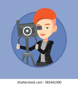 Caucasian cameraman looking through movie camera on a tripod. Cameraman with professional video camera. Cameraman taking a video. Vector flat design illustration in the circle isolated on background.